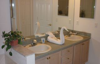 bathroom with tub, twin sinks and walk in shower
